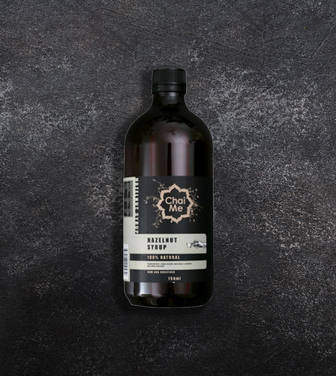 A bottle of Hazelnut Syrup on a textured dark background.