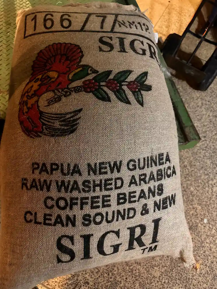 Full hessian sack of unroasted green coffee beans, specialty-grade raw beans ideal for home roasting or wholesale supply.