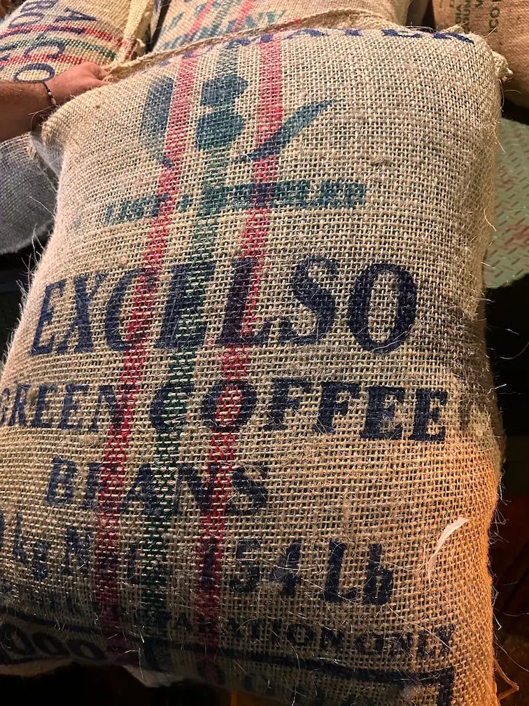 Full hessian sack of unroasted green coffee beans, specialty-grade raw beans ideal for home roasting or wholesale supply.